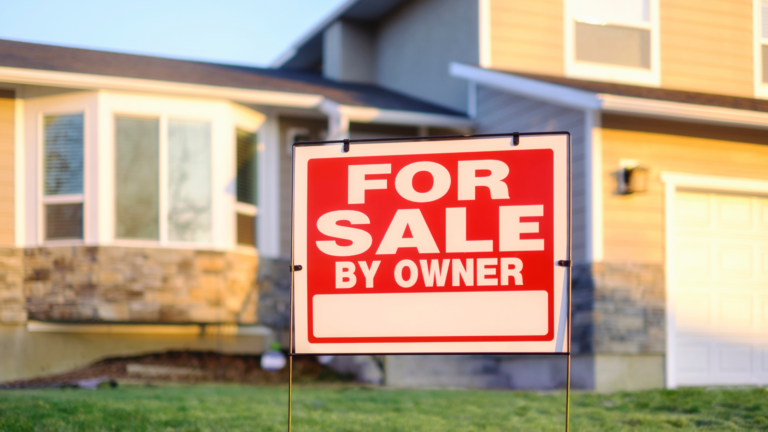 A house with a for sale by owner sign