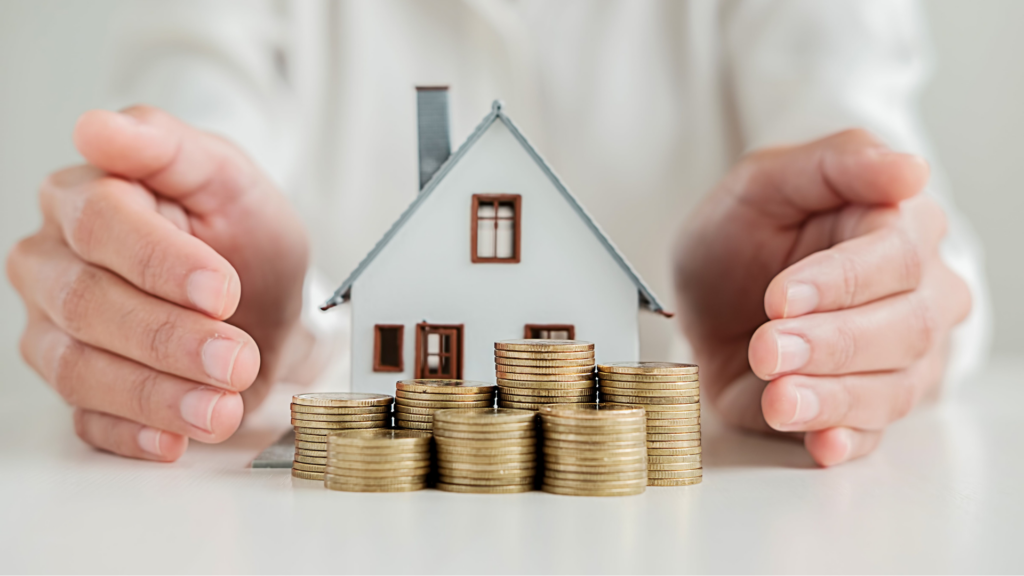 Person with a miniature house and money