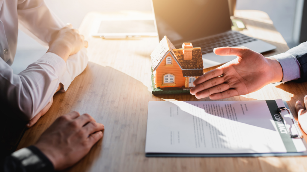 Three people having a conversation over paperwork