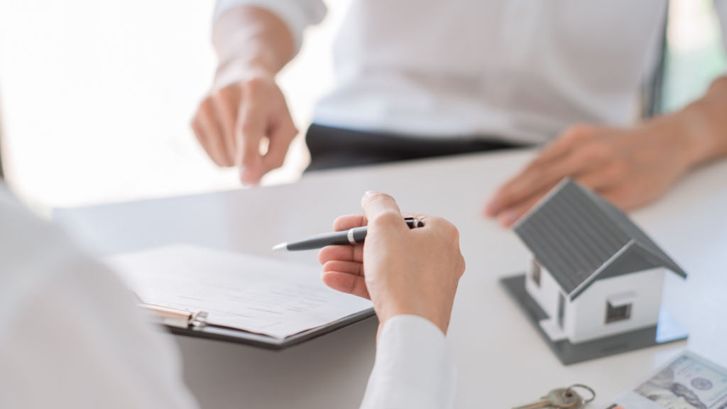 One person with a pen explaining things on a paper