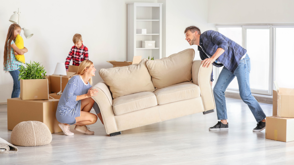 People rearranging furniture in the living room
