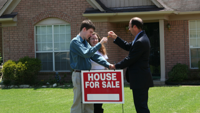 Agent fist-bumping with homeowner selling house